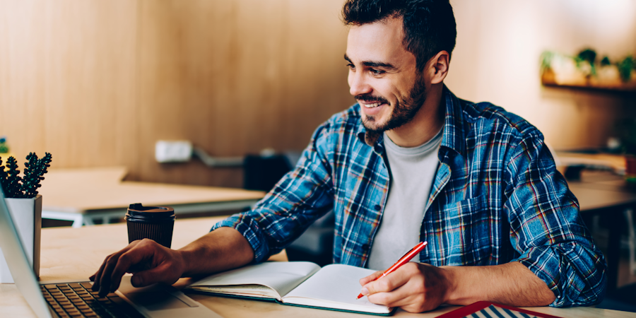 man smiling at laptop